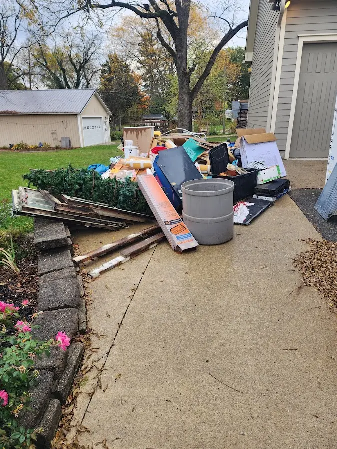 Dumpster being loaded with debris for 10 Yard Dumpster Rental in Traverse City